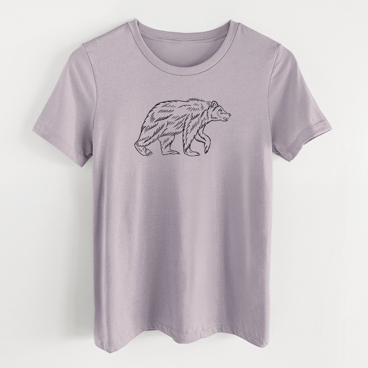 Light violet women's relaxed fit cotton t-shirt laid flat, printed with a black ink illustration of a brown bear walking.