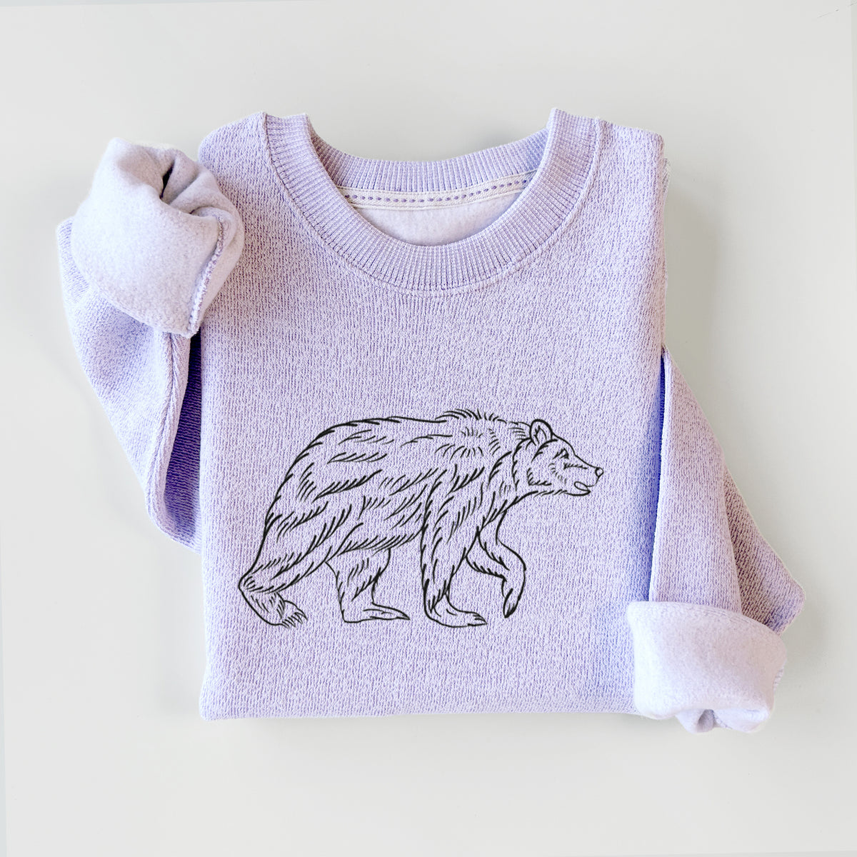 Ice purple knit sweatshirt printed with a black ink illustration of a brown bear walking, styled flat.