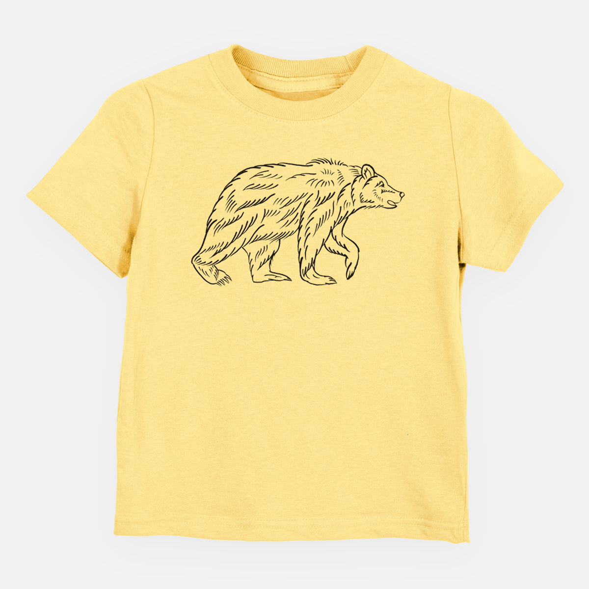 Butter yellow toddler t-shirt laid flat, printed with a black ink illustration of a brown bear walking.
