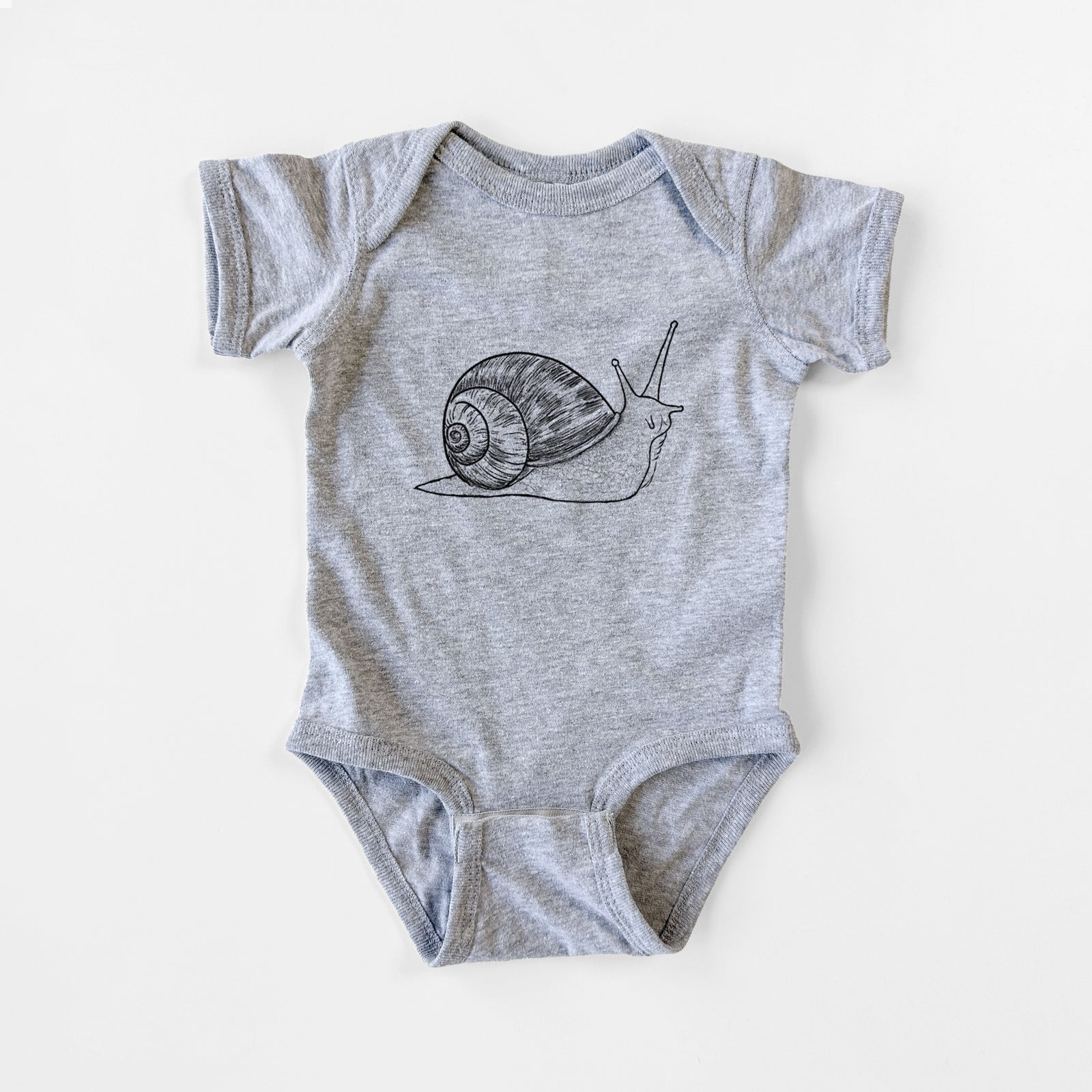 Grey baby bodysuit laid flat, printed with a detailed black ink illustration of a brown garden snail with its spiral shell.