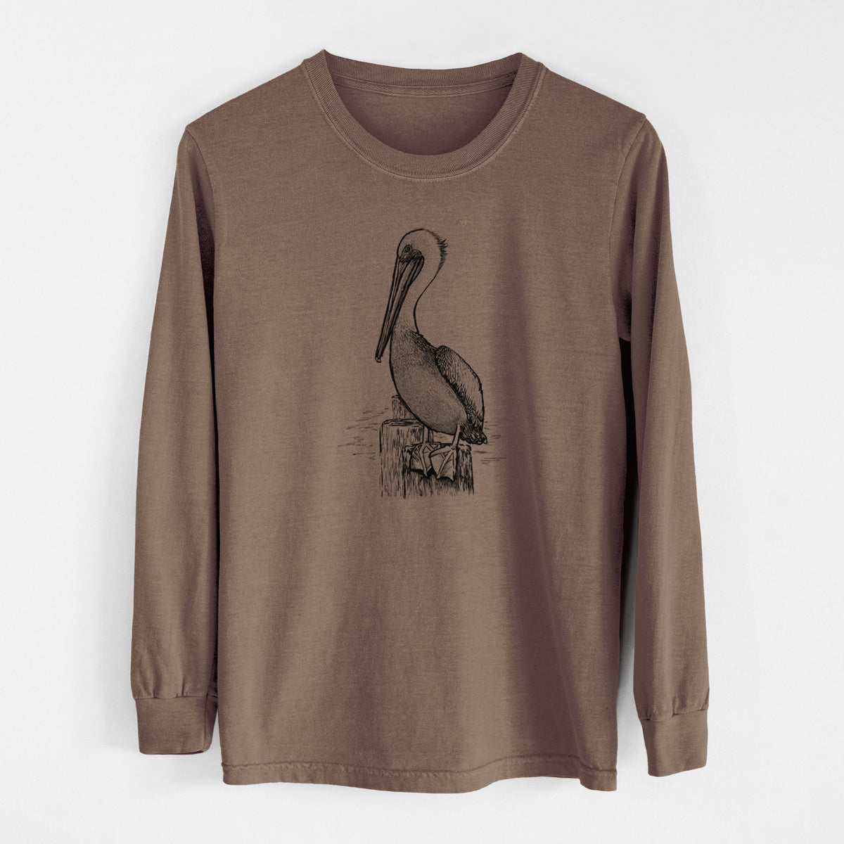 Espresso brown Comfort Colors long sleeve shirt laid flat, printed with a detailed black ink illustration of a brown pelican perched on a wooden piling.