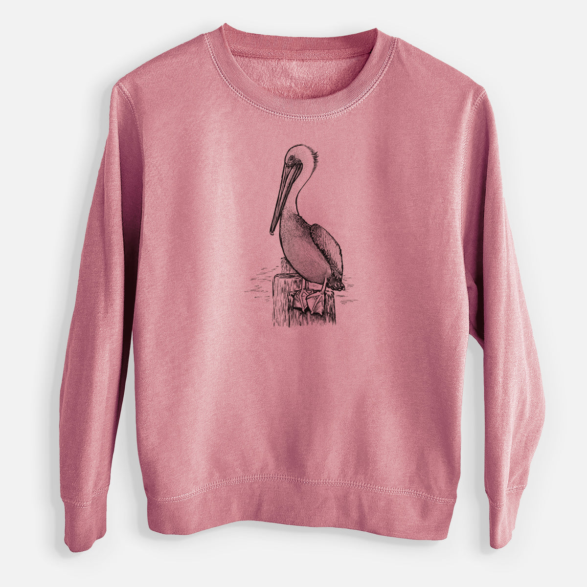Mauve pink youth crewneck sweatshirt laid flat, printed with a detailed black ink illustration of a brown pelican perched on a wooden piling.