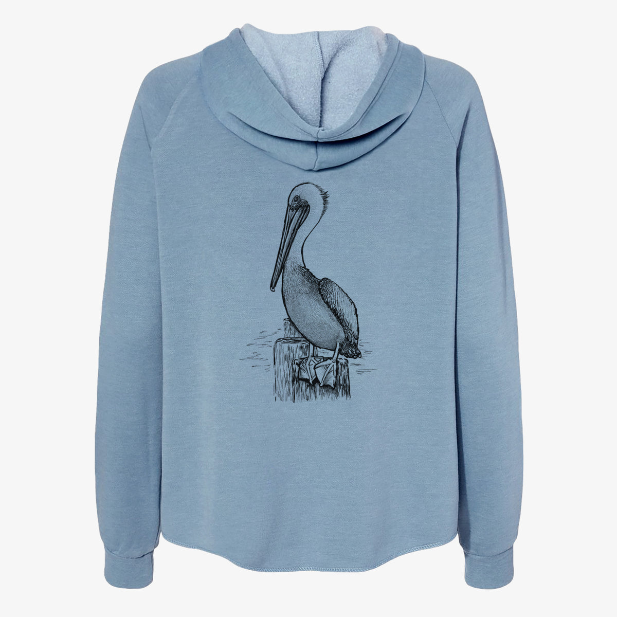 Misty blue women's Cali Wave zip-up sweatshirt laid flat, printed with a detailed black ink illustration of a brown pelican perched on a wooden piling.