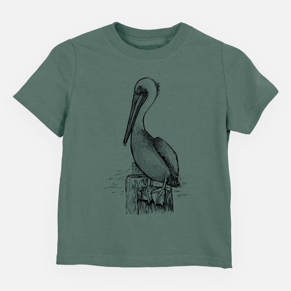 Basil green toddler t-shirt laid flat, printed with a detailed black ink illustration of a brown pelican perched on a wooden piling.