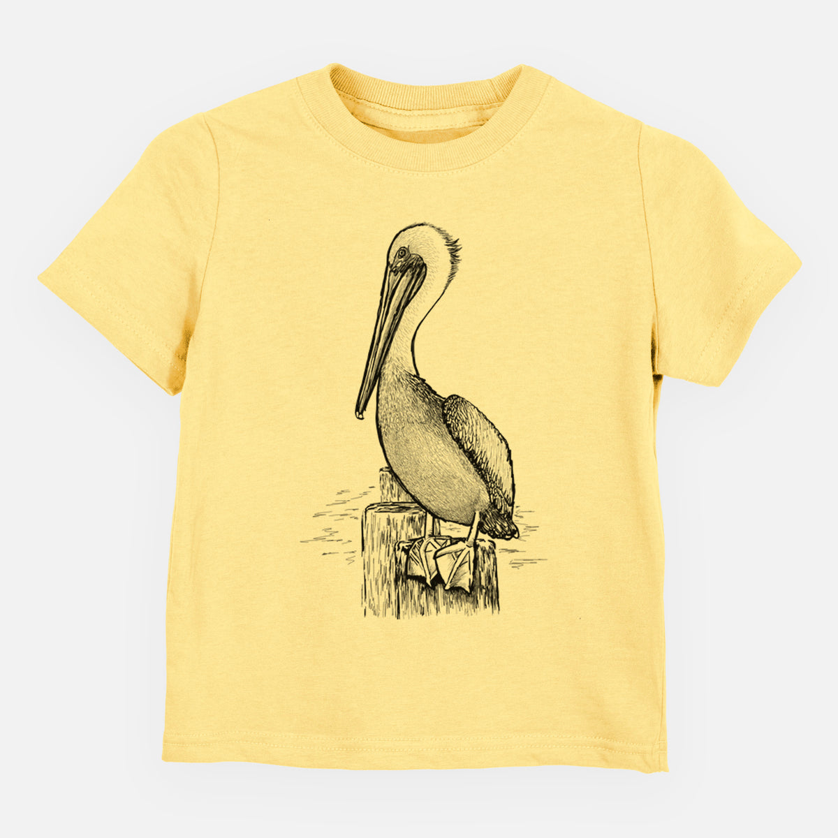 Butter yellow toddler t-shirt laid flat, printed with a detailed black ink illustration of a brown pelican perched on a wooden piling.
