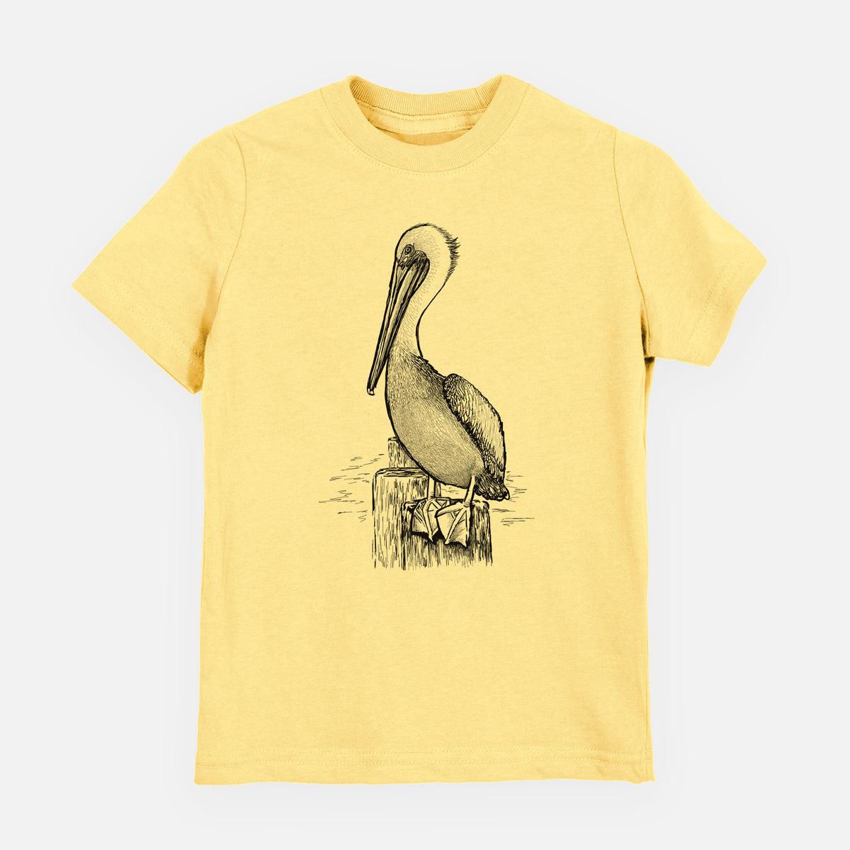 Butter yellow youth t-shirt laid flat, printed with a detailed black ink illustration of a brown pelican perched on a wooden piling.