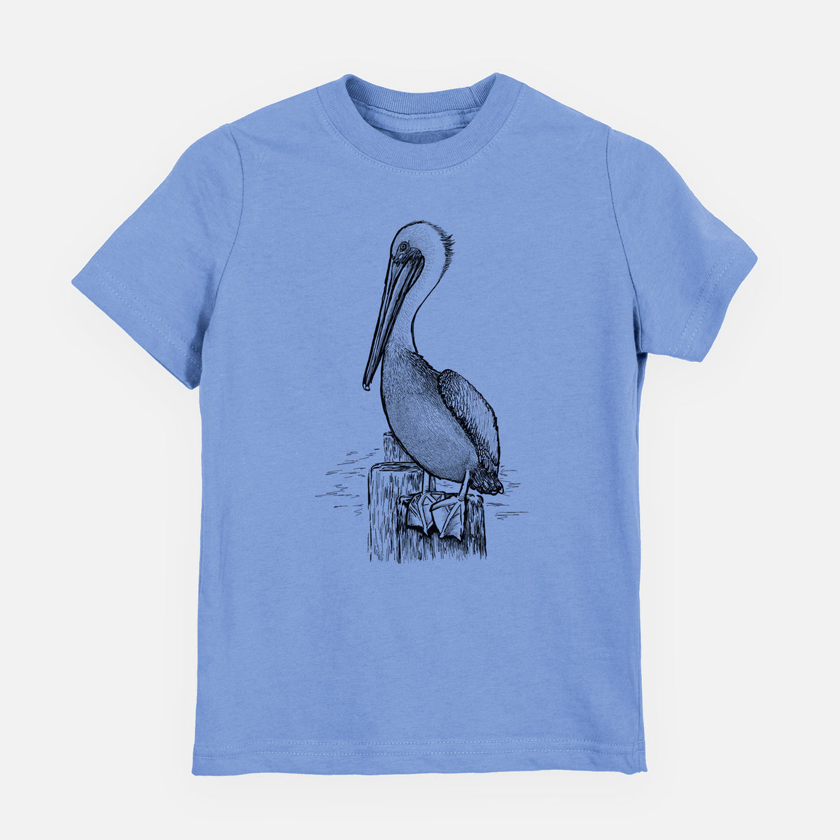 Carolina blue youth t-shirt laid flat, printed with a detailed black ink illustration of a brown pelican perched on a wooden piling.