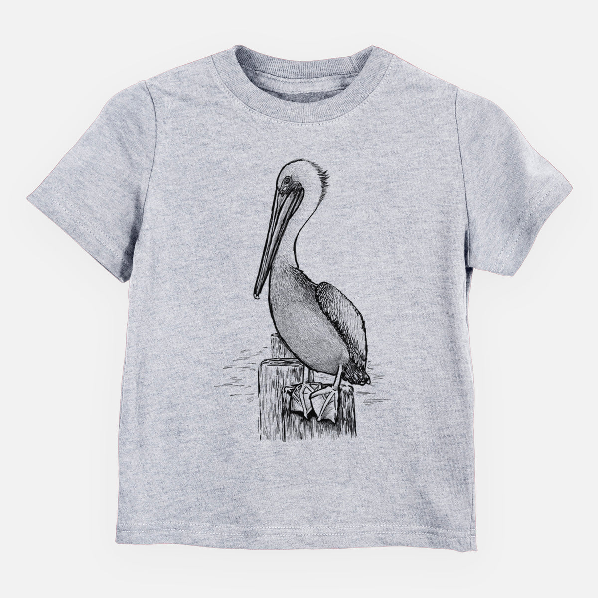 Heather grey toddler t-shirt laid flat, printed with a detailed black ink illustration of a brown pelican perched on a wooden piling.