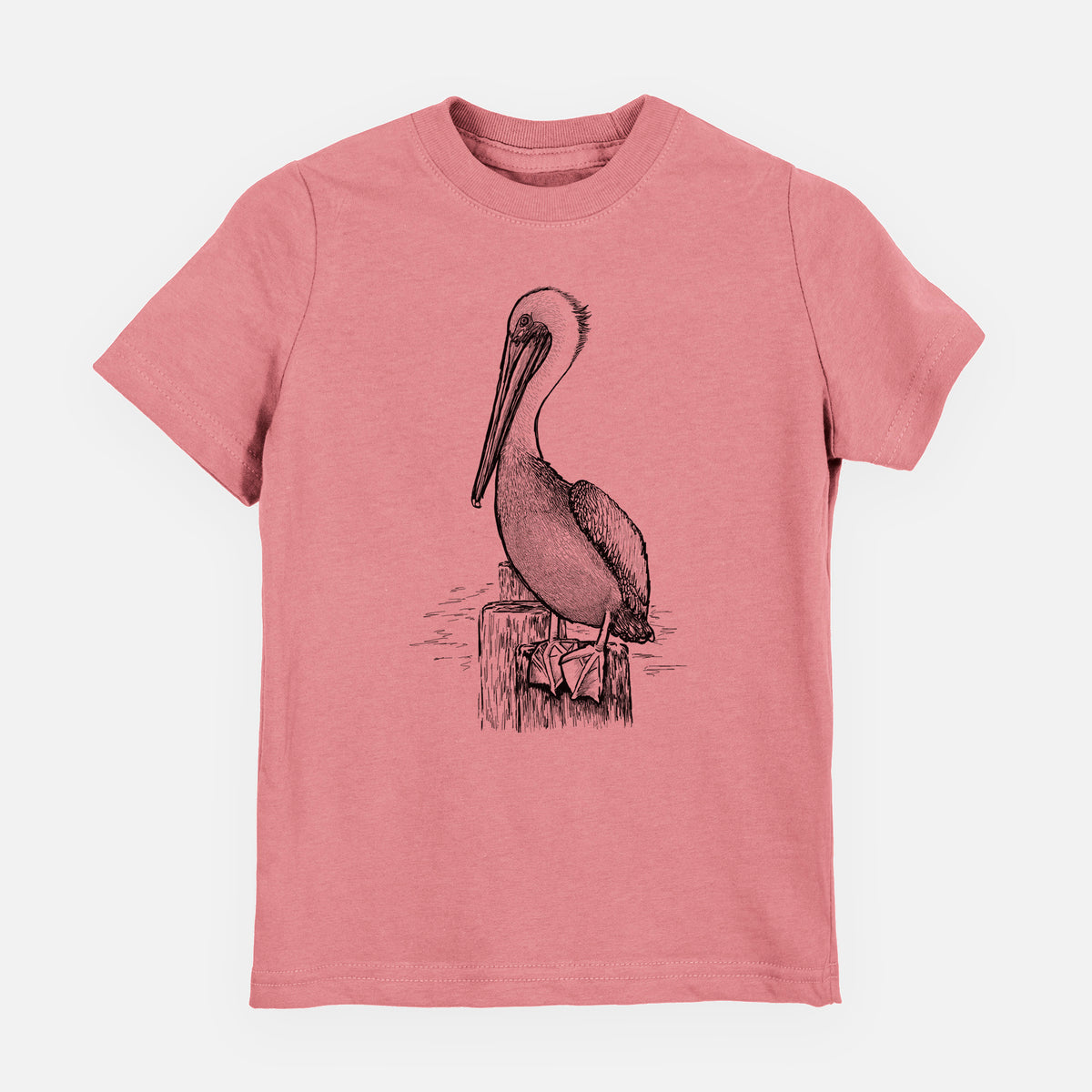 Mauve pink youth t-shirt laid flat, printed with a detailed black ink illustration of a brown pelican perched on a wooden piling.