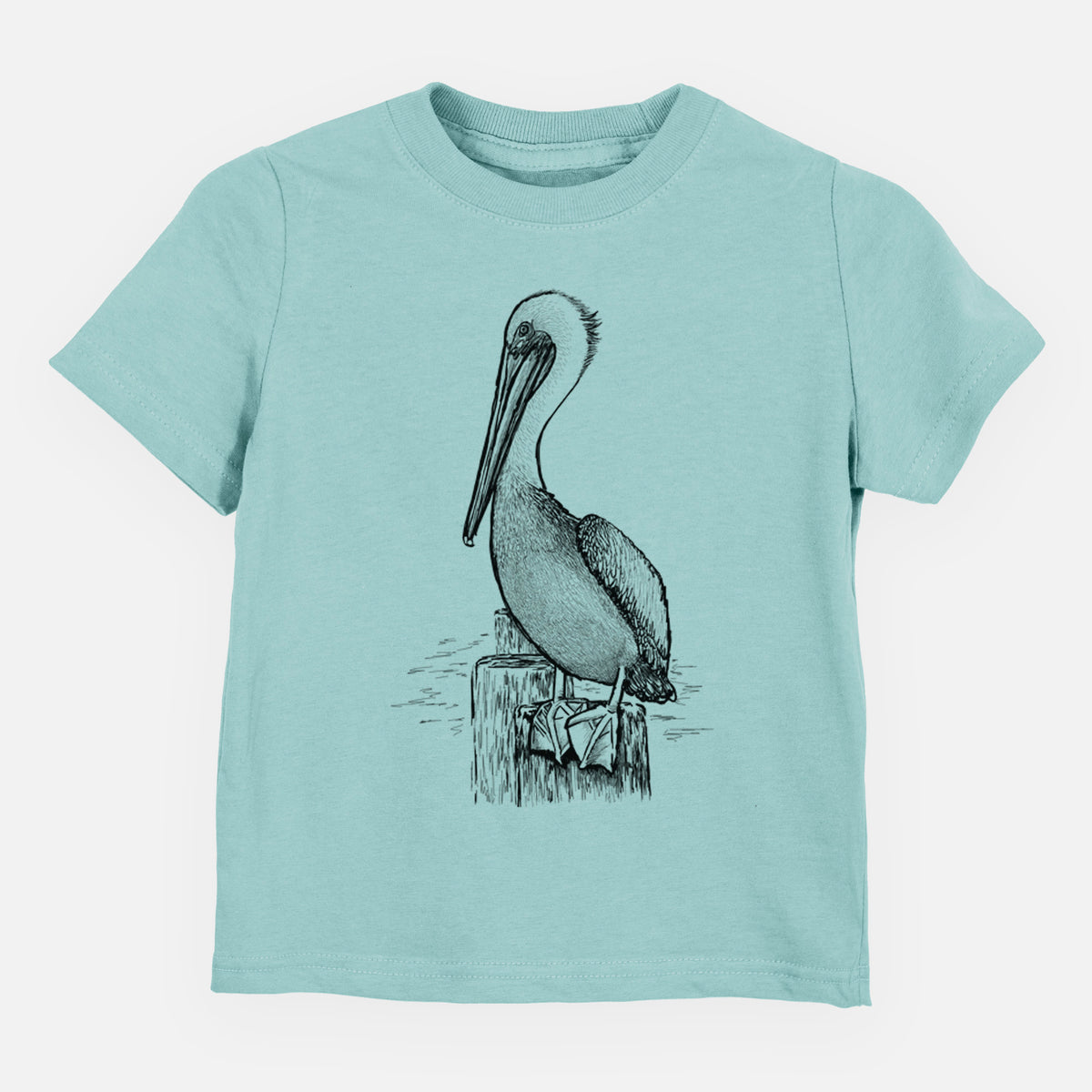 Saltwater toddler t-shirt laid flat, printed with a detailed black ink illustration of a brown pelican perched on a wooden piling.
