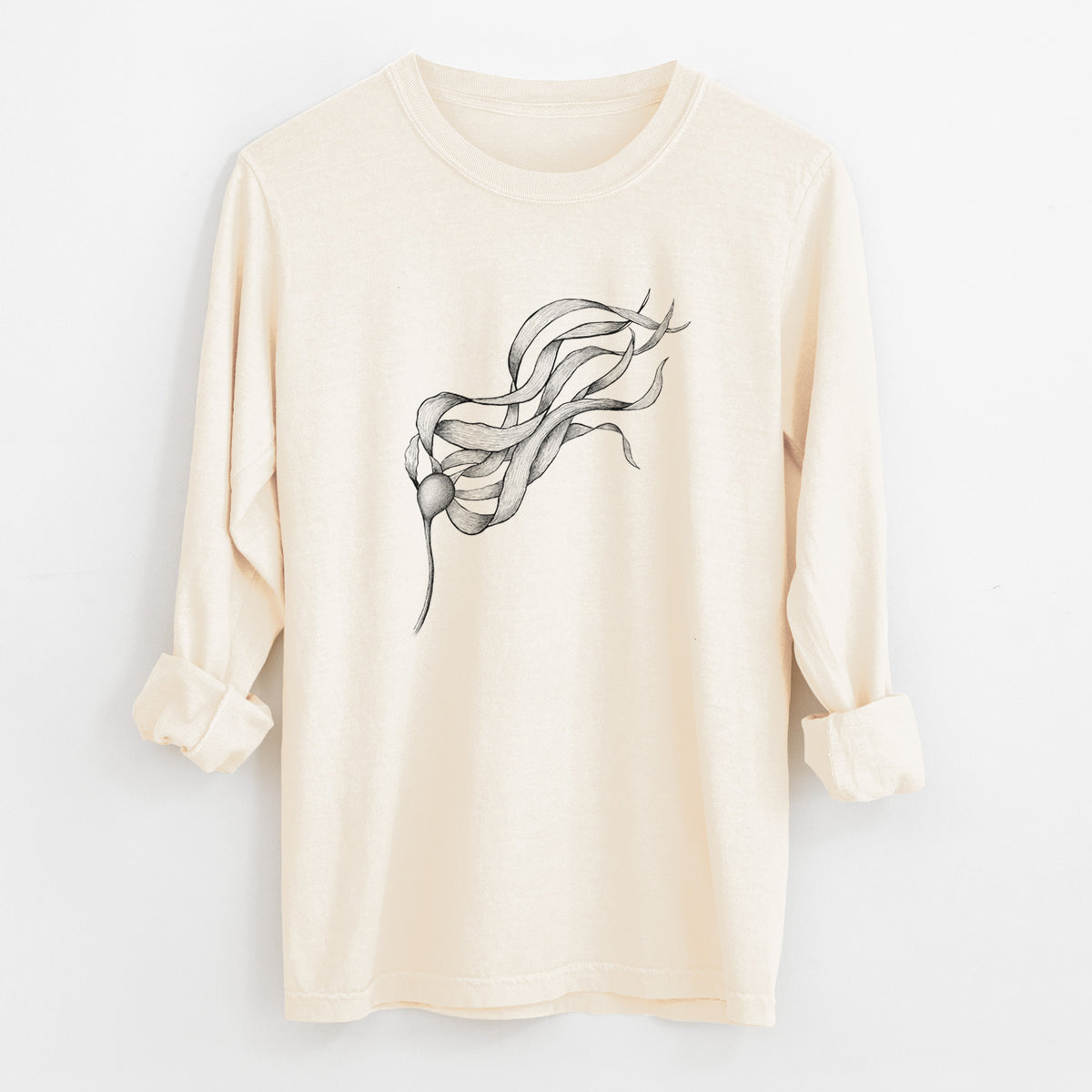 Ivory Comfort Colors long sleeve shirt laid flat with the cuffs rolled, printed with a black ink line drawing of a strand of bull kelp with long flowing blades.