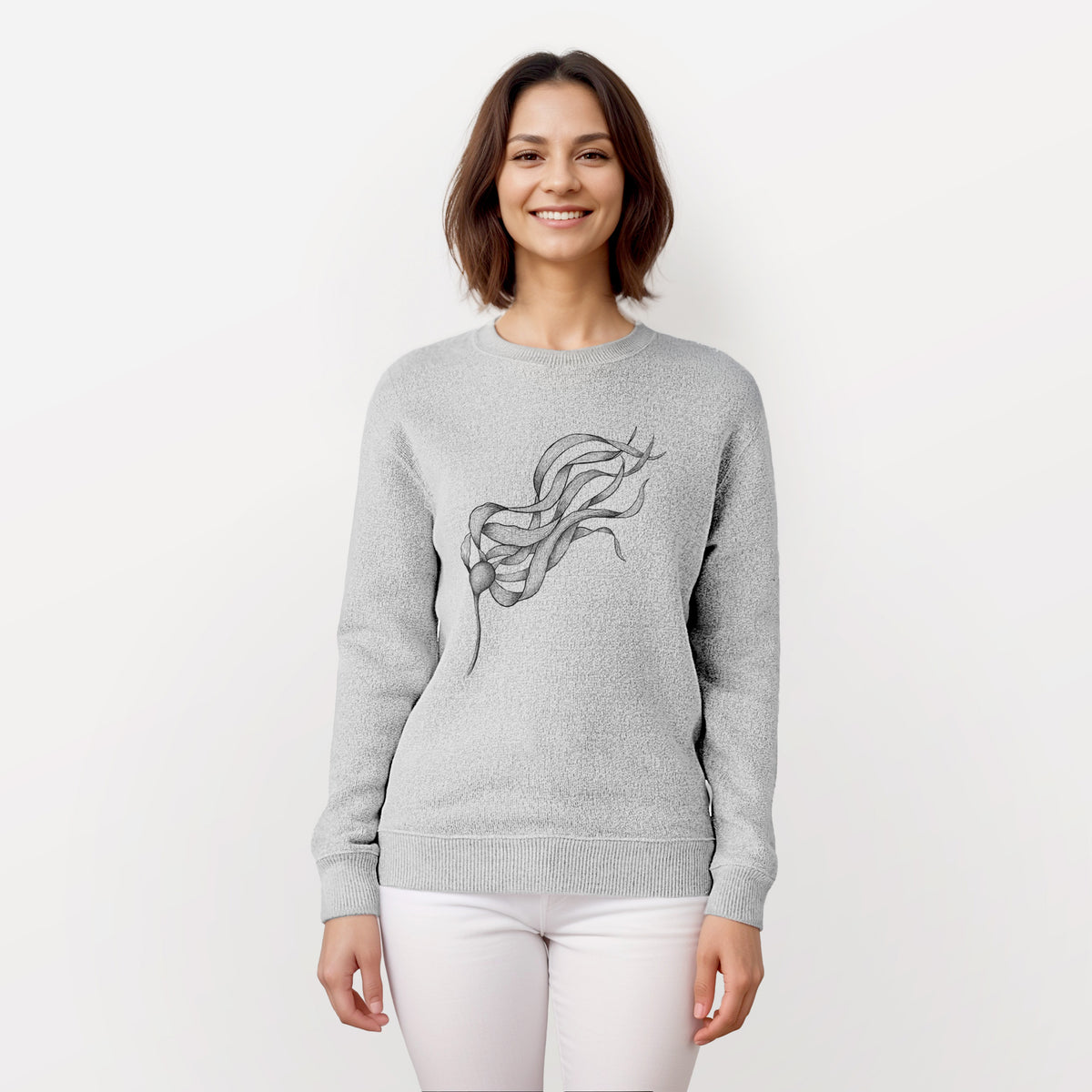 Woman wearing a knit sweatshirt printed with a black ink line drawing of a strand of bull kelp with long flowing blades.