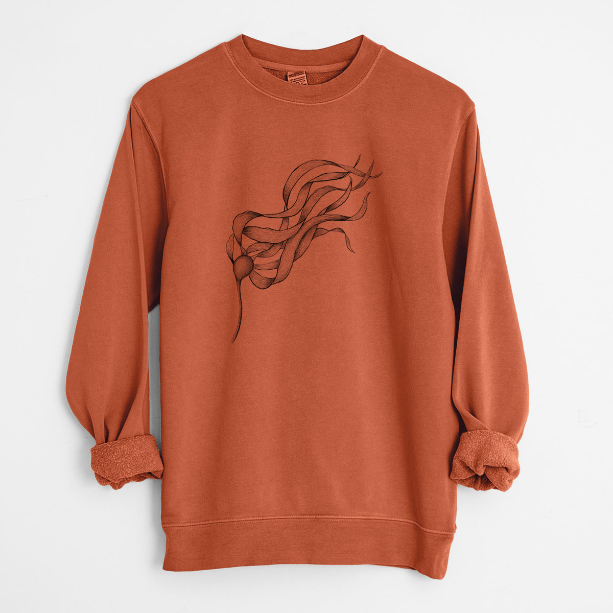 Amber orange pigment dyed crewneck sweatshirt laid flat with the sleeves rolled, printed with a black ink line drawing of a strand of bull kelp with long flowing blades.