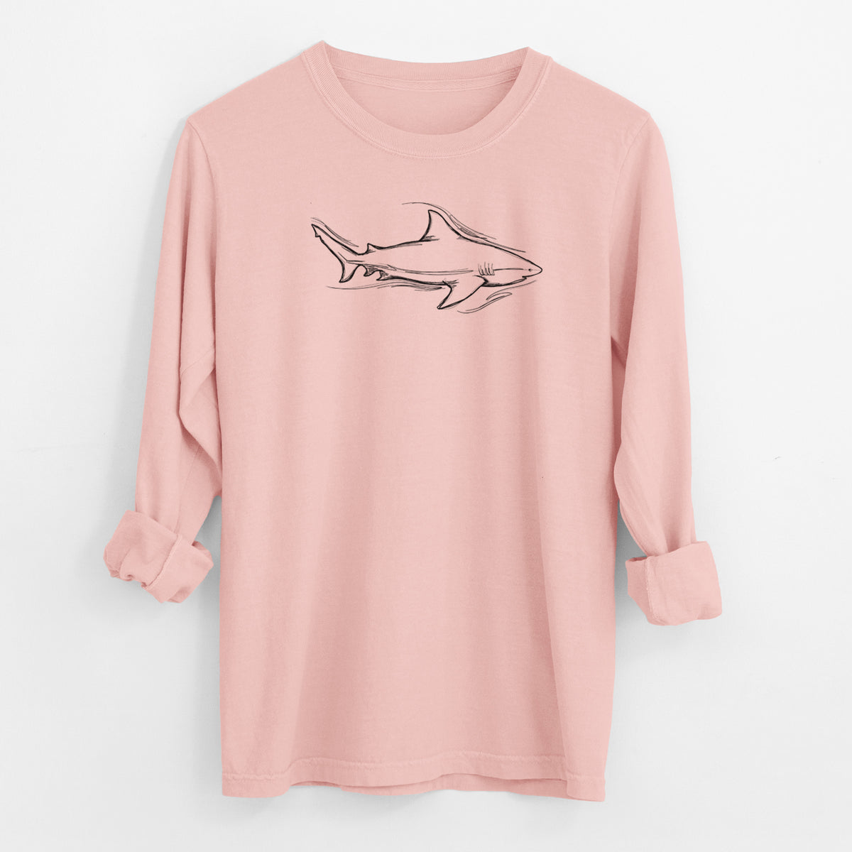 Peachy Comfort Colors long sleeve shirt laid flat with the cuffs rolled, printed with a black ink illustration of a bull shark swimming.