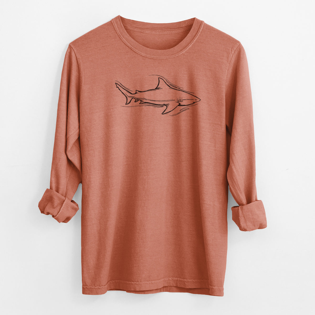 Yam burnt orange Comfort Colors long sleeve shirt laid flat with the cuffs rolled, printed with a black ink illustration of a bull shark swimming.