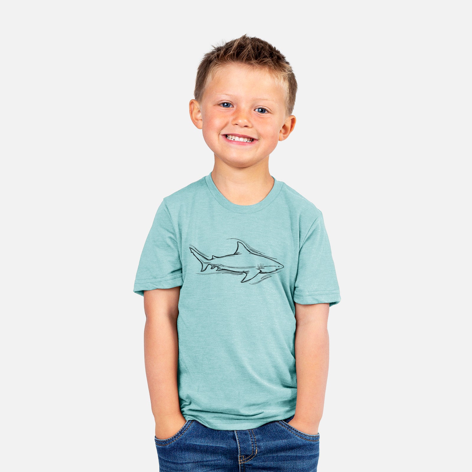 Two youth t-shirts in different colors on hangers, printed with a black ink illustration of a bull shark swimming.