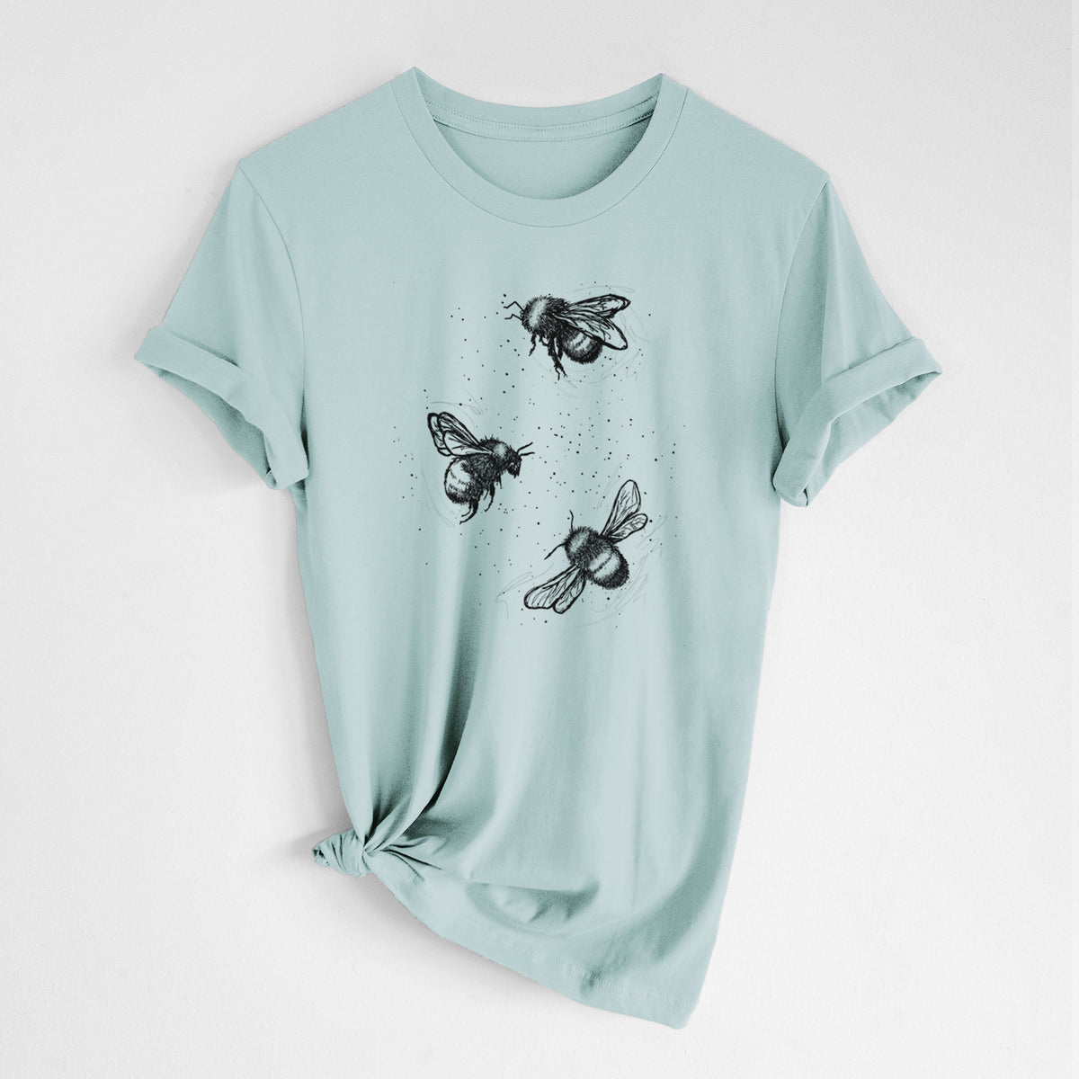 Dusty blue lightweight cotton t-shirt laid flat with the sleeves rolled, printed with a black ink illustration of three bumble bees flying.