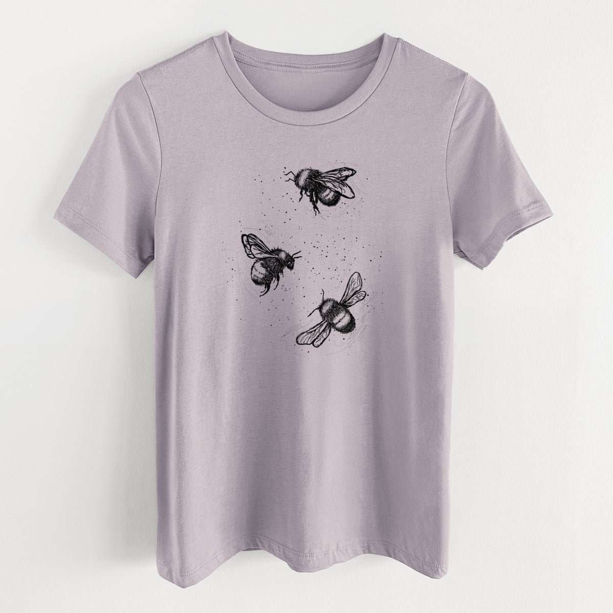 Light violet women's relaxed fit cotton t-shirt laid flat, printed with a black ink illustration of three bumble bees flying.