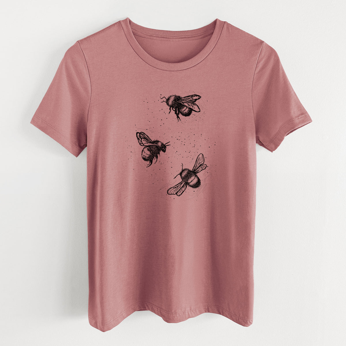 Mauve pink women's relaxed fit cotton t-shirt laid flat, printed with a black ink illustration of three bumble bees flying.