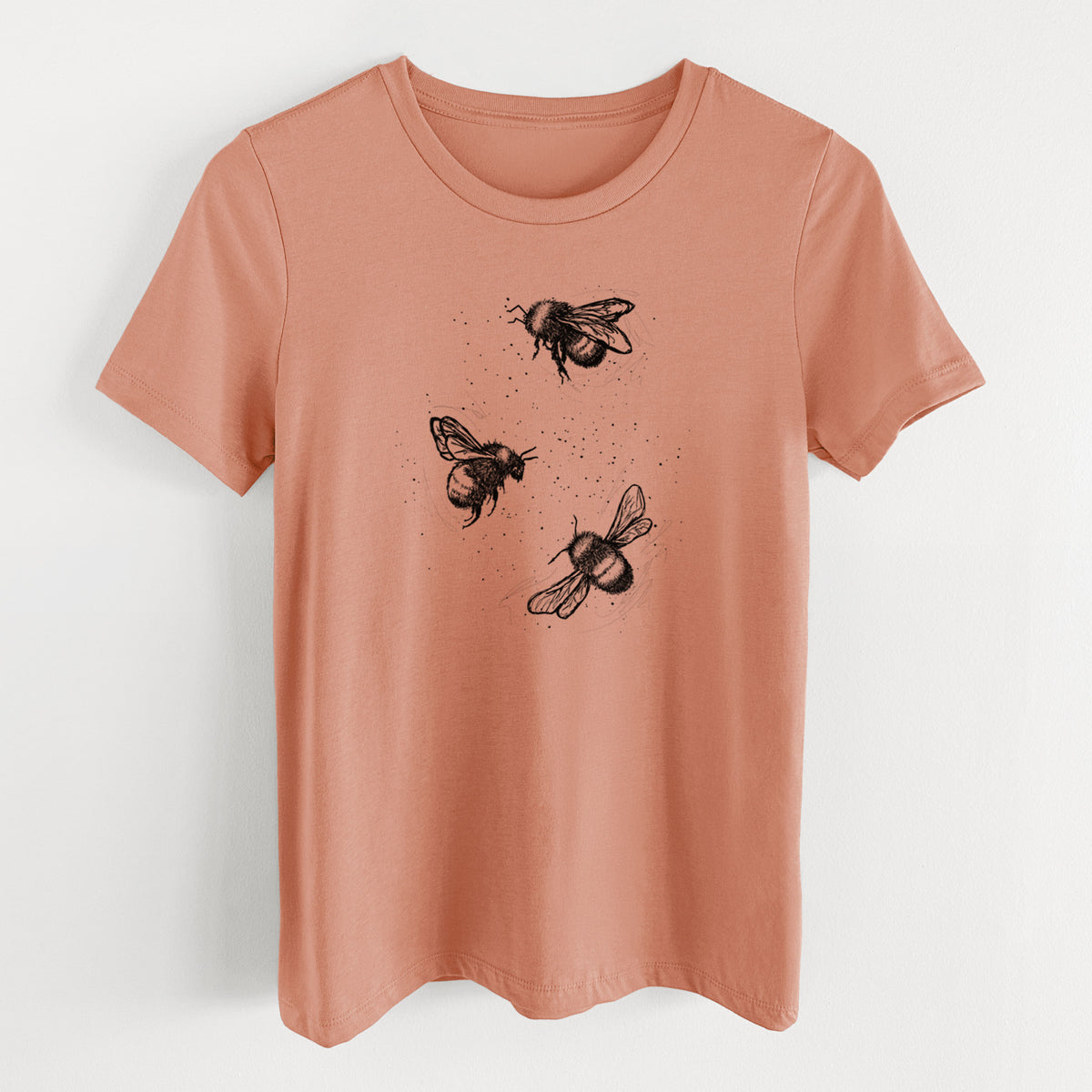Terracotta orange women's relaxed fit cotton t-shirt laid flat, printed with a black ink illustration of three bumble bees flying.