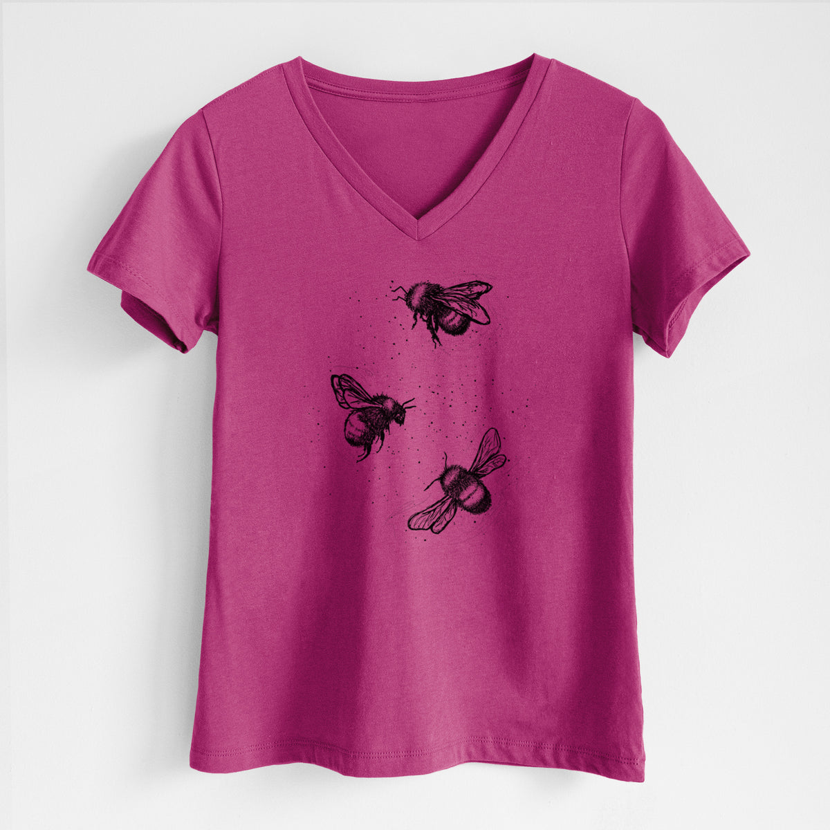 Berry pink women's relaxed fit cotton V-neck t-shirt laid flat, printed with a black ink illustration of three bumble bees flying.