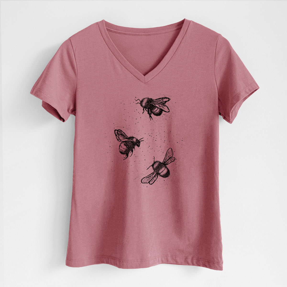 Mauve pink women's relaxed fit cotton V-neck t-shirt laid flat, printed with a black ink illustration of three bumble bees flying.
