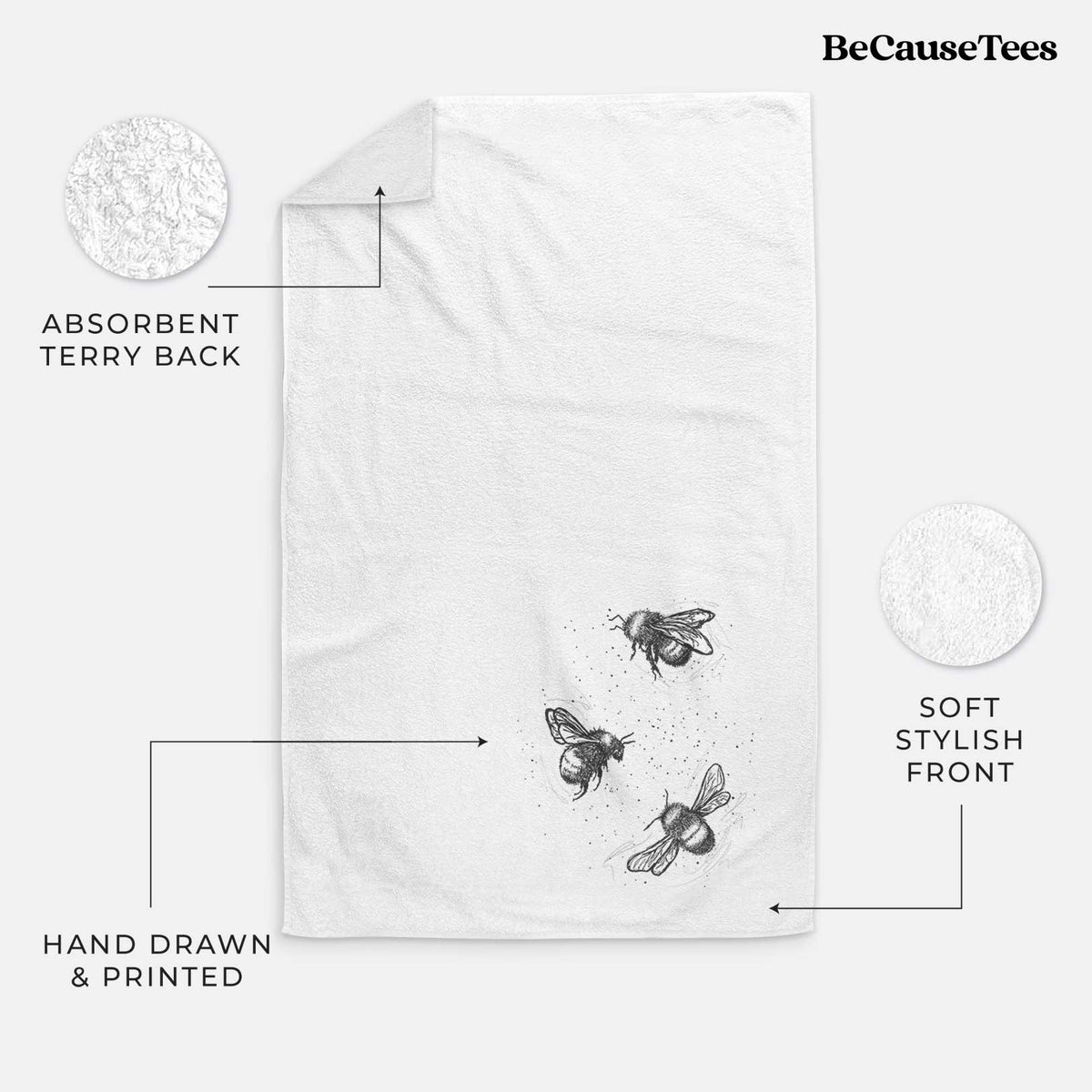 White hand towel printed with a black ink illustration of three bumble bees flying.