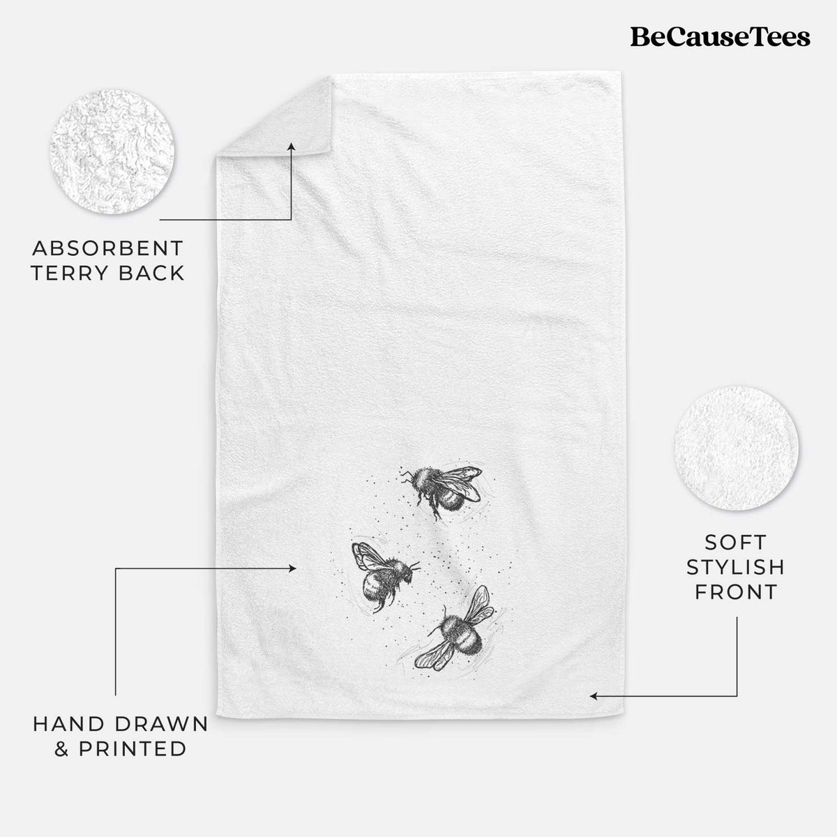 White hand towel printed with a black ink illustration of three bumble bees flying.