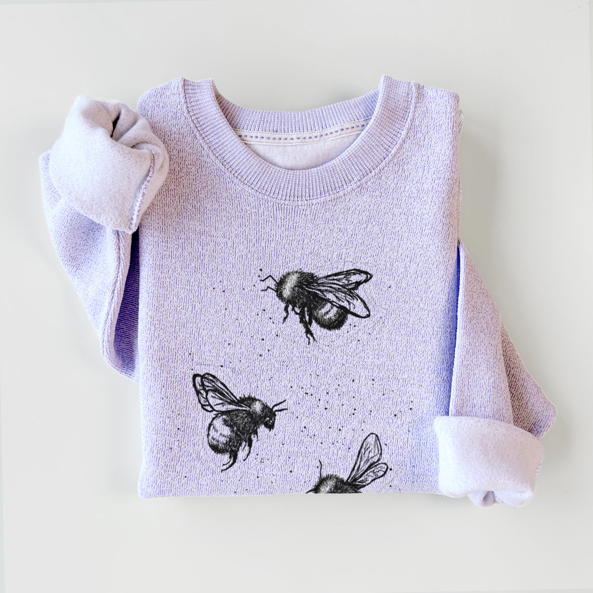 Ice purple knit sweatshirt printed with a black ink illustration of three bumble bees flying, styled flat.