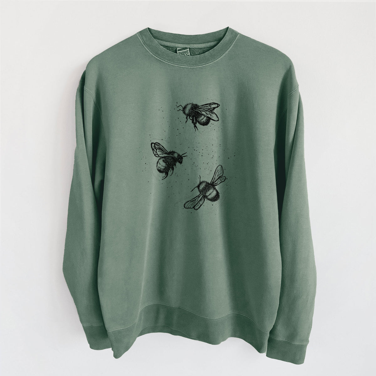 Alpine green pigment dyed crewneck sweatshirt laid flat, printed with a black ink illustration of three bumble bees flying.