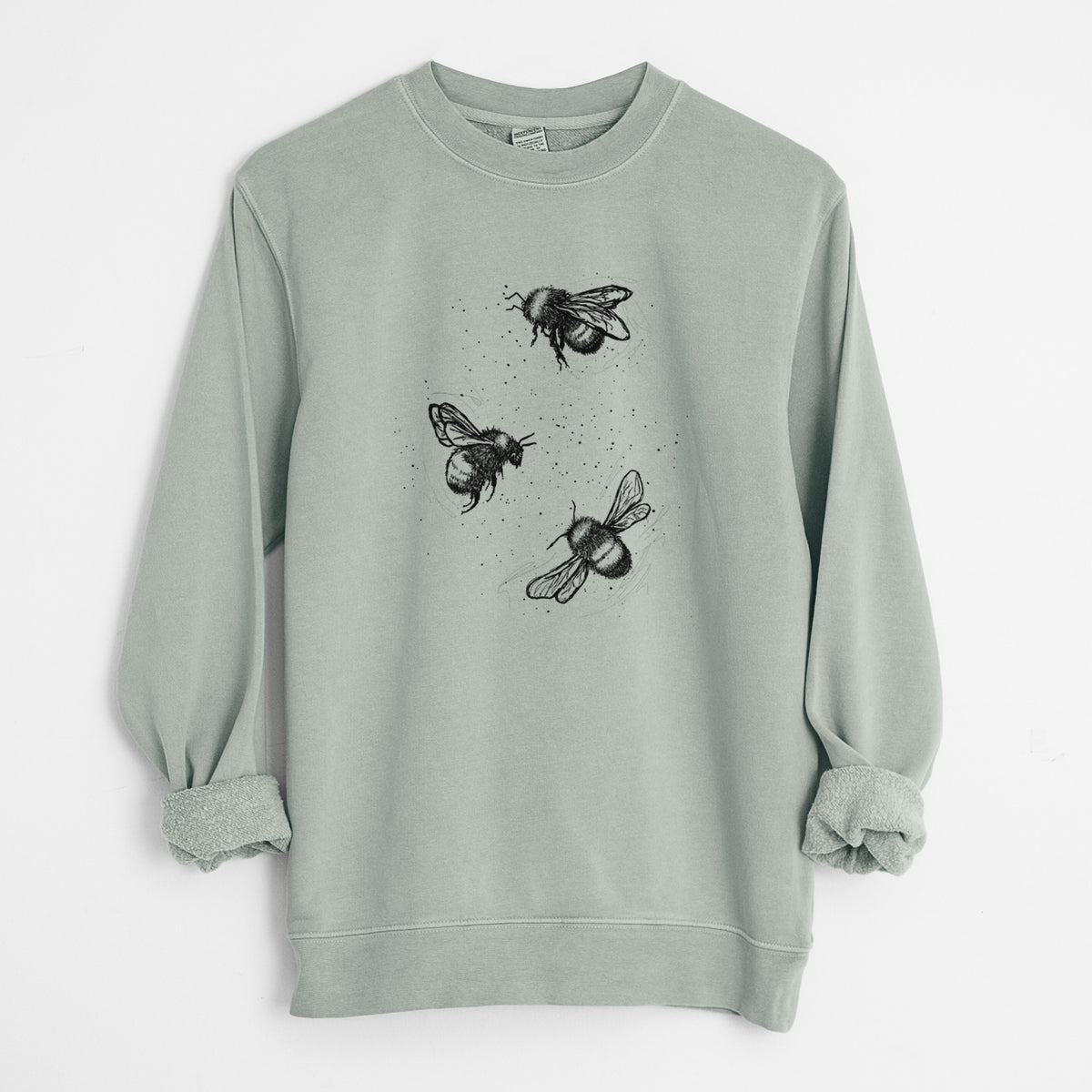 Sage green pigment dyed crewneck sweatshirt laid flat with the sleeves rolled, printed with a black ink illustration of three bumble bees flying.