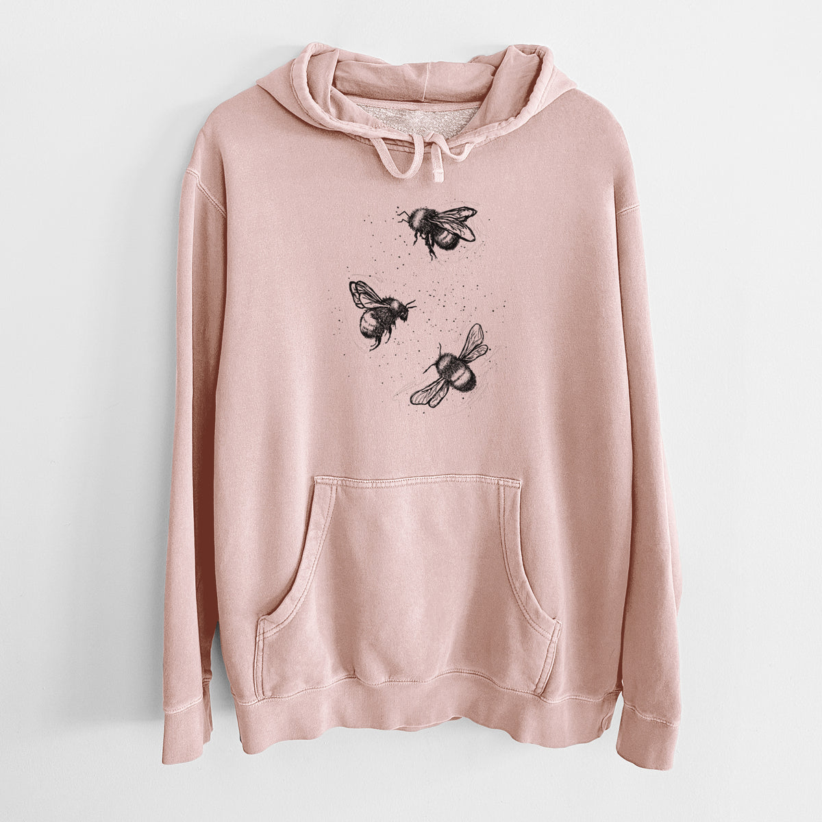 Dusty pink pigment dyed hoodie laid flat, printed with a black ink illustration of three bumble bees flying.