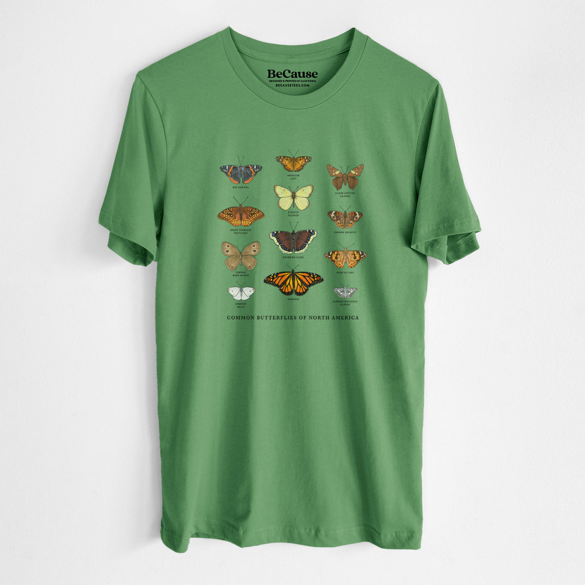 Leaf green lightweight cotton t-shirt laid flat, printed with a full-color chart of common butterflies of North America, each labeled with its species.