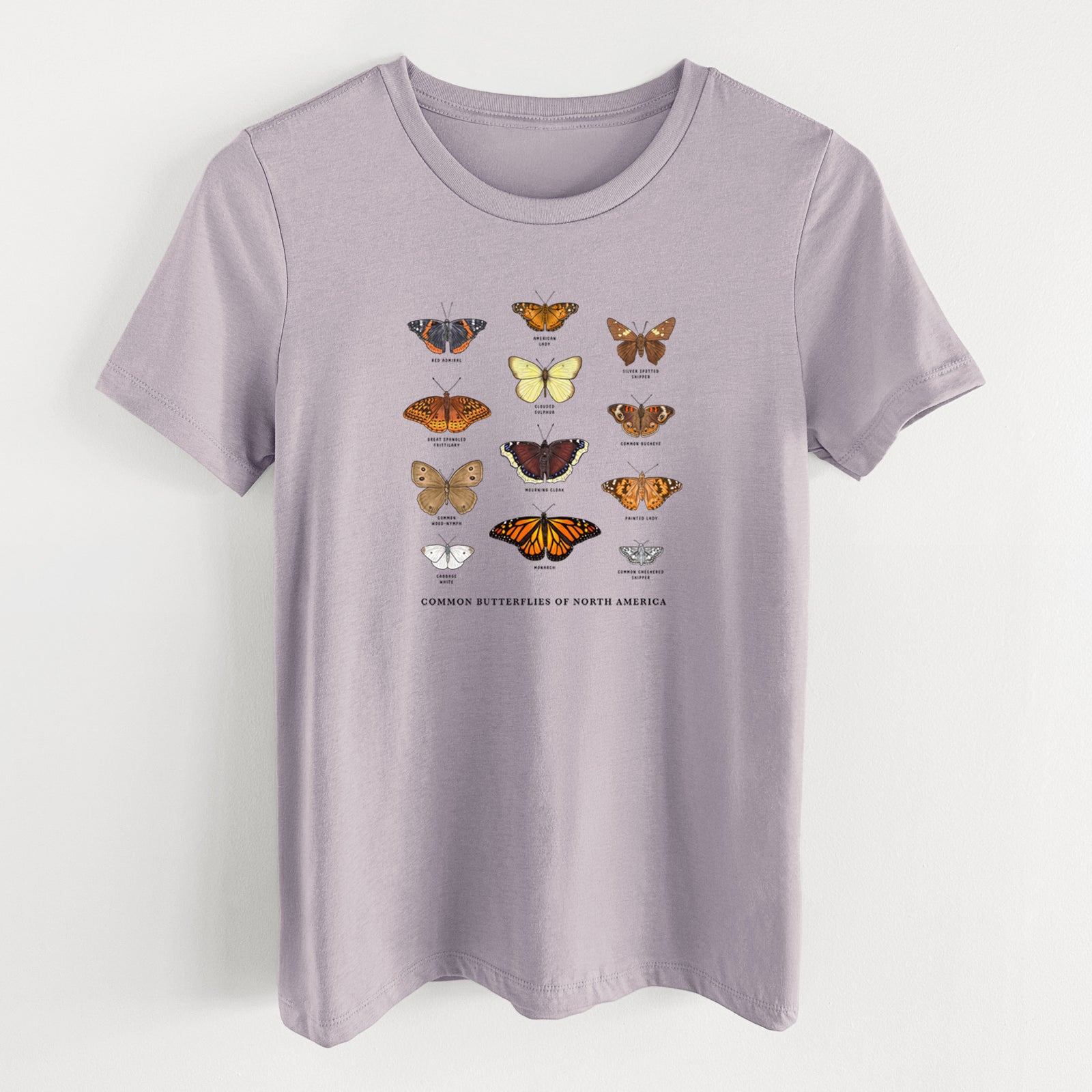 Light violet women's relaxed fit cotton t-shirt laid flat, printed with a full-color chart of common butterflies of North America, each labeled with its species.