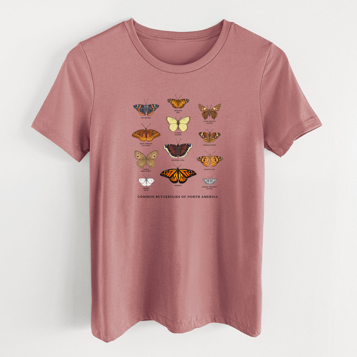 Mauve pink women's relaxed fit cotton t-shirt laid flat, printed with a full-color chart of common butterflies of North America, each labeled with its species.