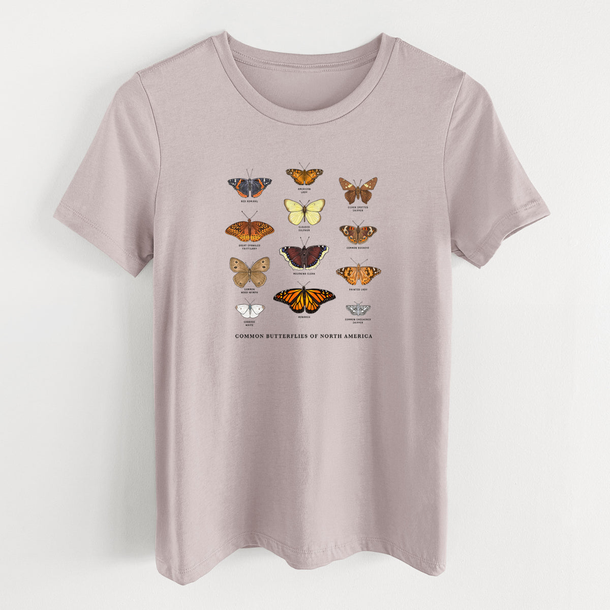Pink gravel women's relaxed fit cotton t-shirt laid flat, printed with a full-color chart of common butterflies of North America, each labeled with its species.