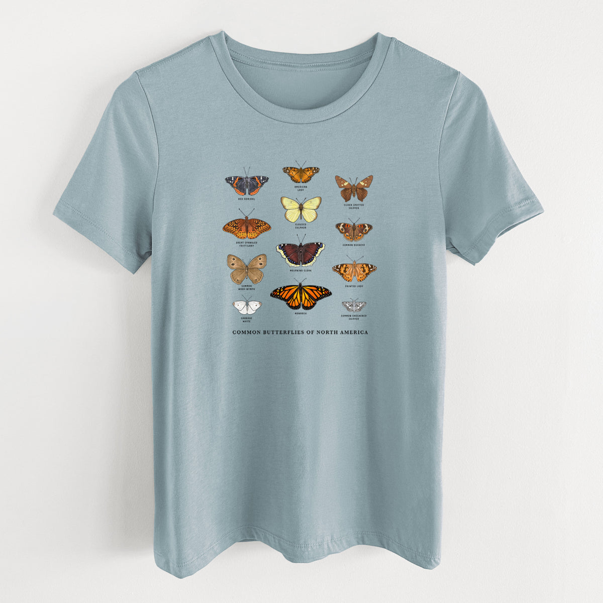 Vintage denim women's relaxed fit cotton t-shirt laid flat, printed with a full-color chart of common butterflies of North America, each labeled with its species.