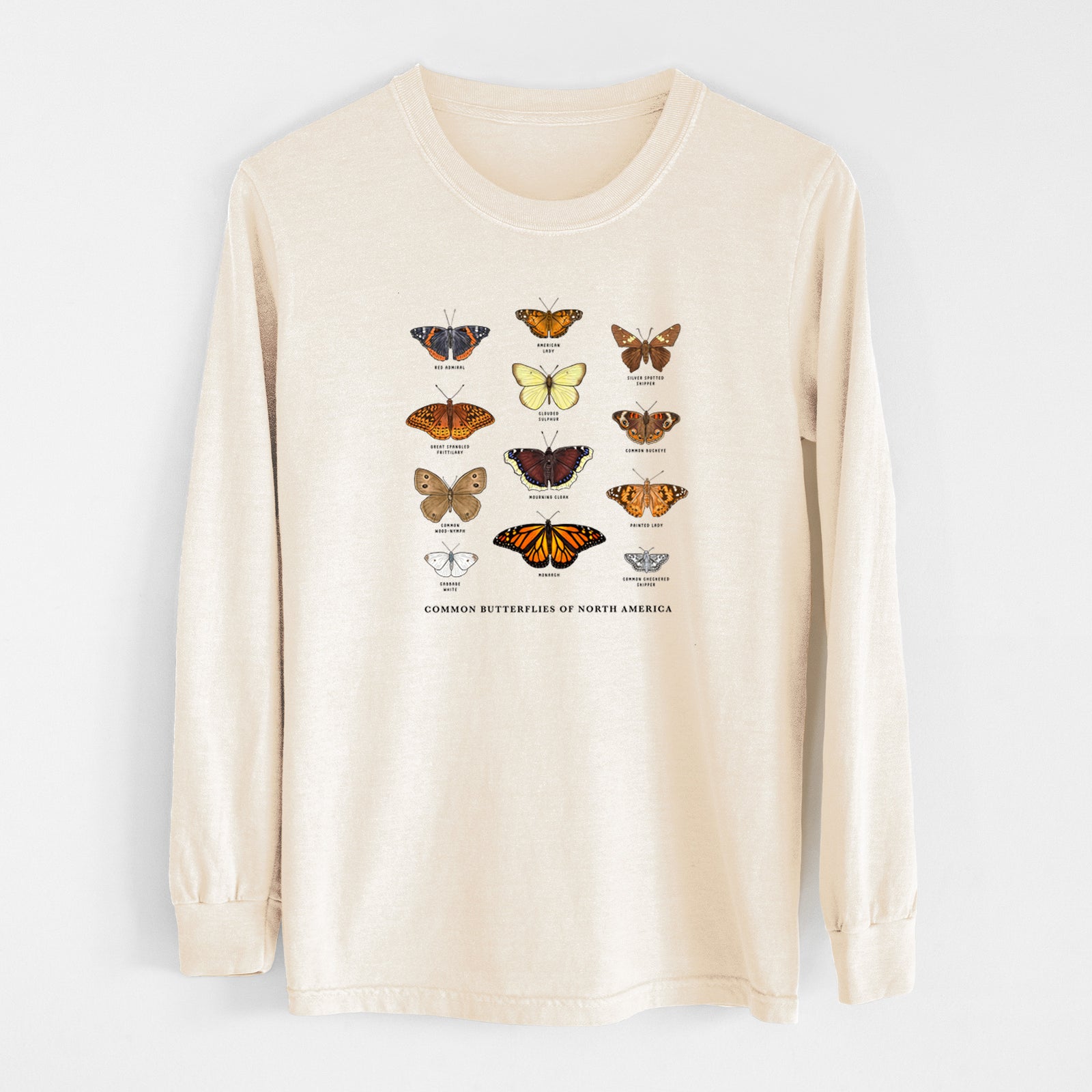 Ivory Comfort Colors long sleeve shirt laid flat, printed with a full-color chart of common butterflies of North America, each labeled with its species.