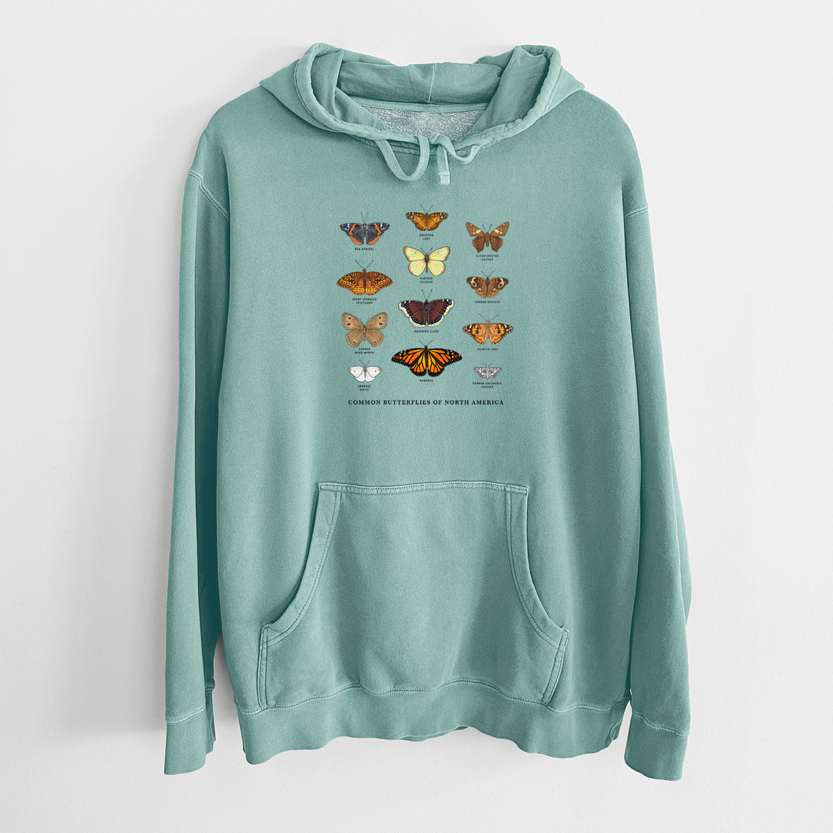 Mint green pigment dyed hoodie laid flat, printed with a full-color chart of common butterflies of North America, each labeled with its species.