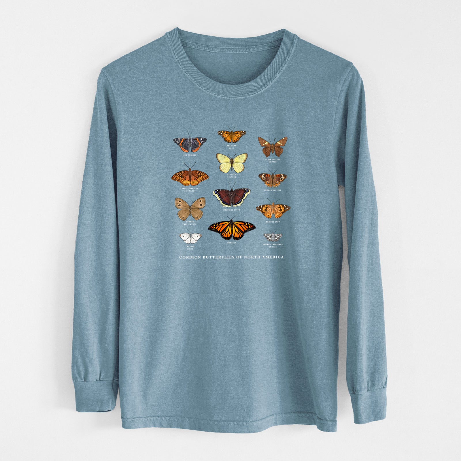 Ivory Comfort Colors long sleeve shirt laid flat, printed with a full-color chart of common butterflies of North America, each labeled with its species.
