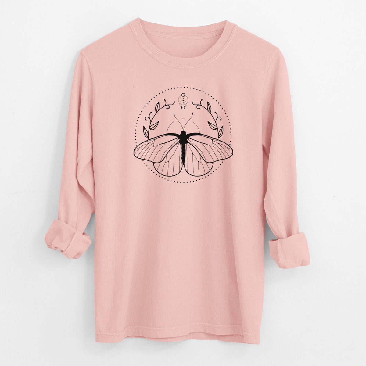 Peachy Comfort Colors long sleeve shirt laid flat with the cuffs rolled, printed with a black ink butterfly inside a circle, framed by moon phases and leaves.