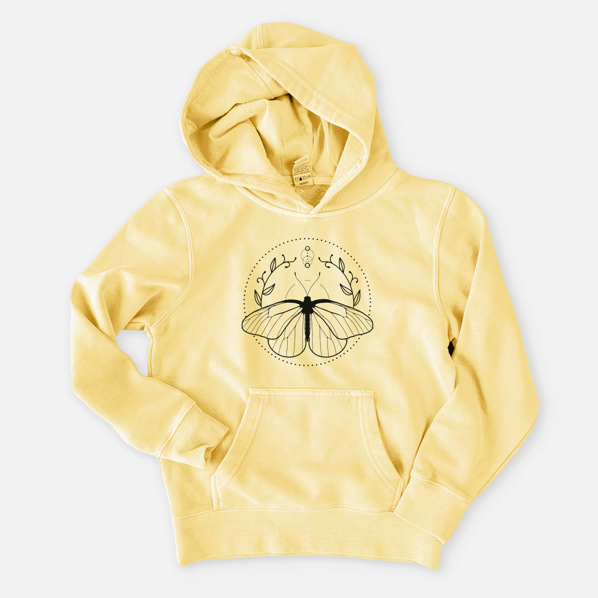 Pigment yellow youth pigment dyed hoodie laid flat, printed with a black ink butterfly inside a circle, framed by moon phases and leaves.