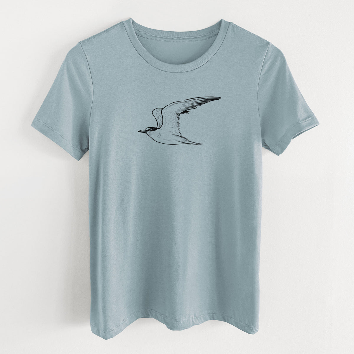 Vintage denim women's relaxed fit cotton t-shirt laid flat, printed with a black ink illustration of a California least tern in flight.