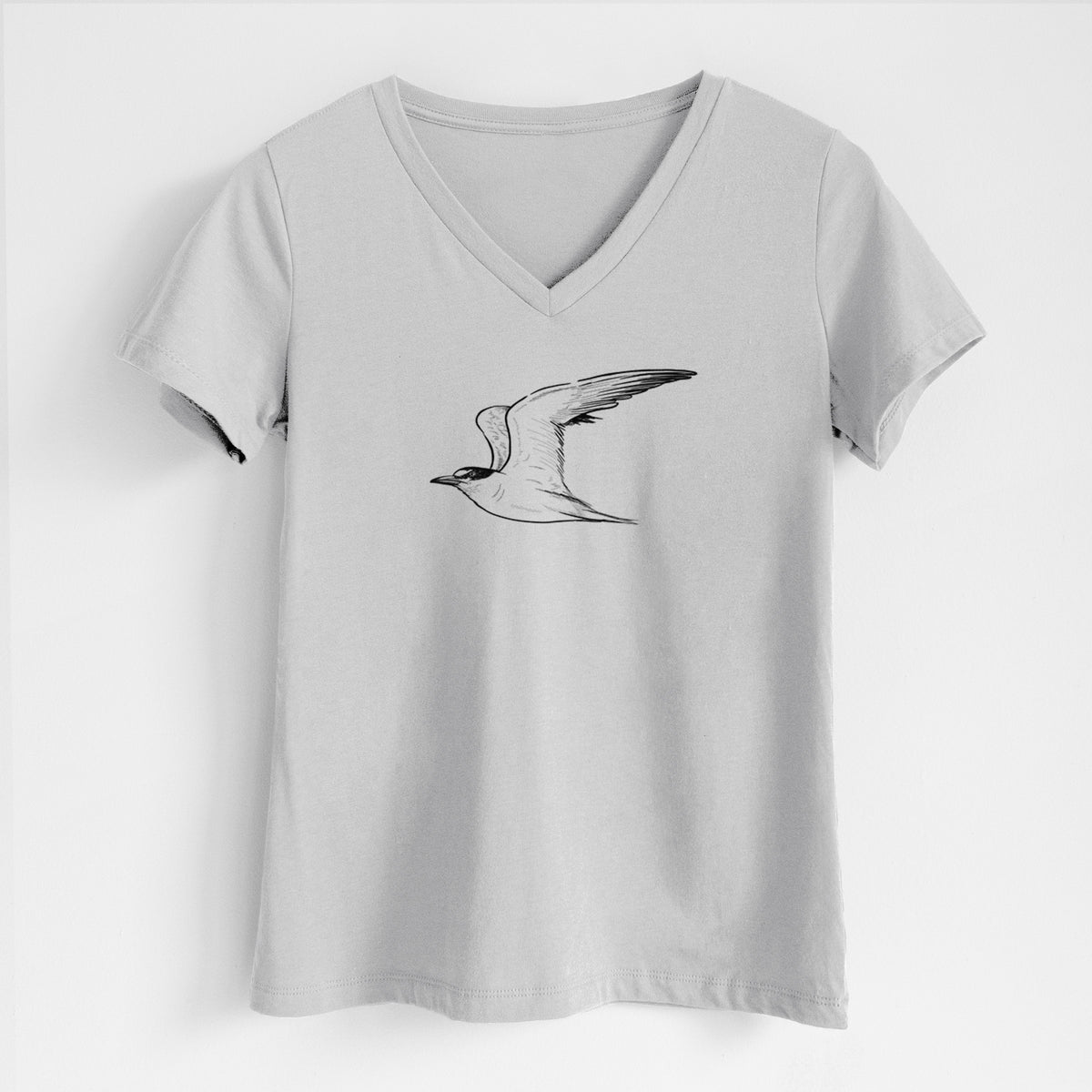 Lunar grey women's relaxed fit cotton V-neck t-shirt laid flat, printed with a black ink illustration of a California least tern in flight.
