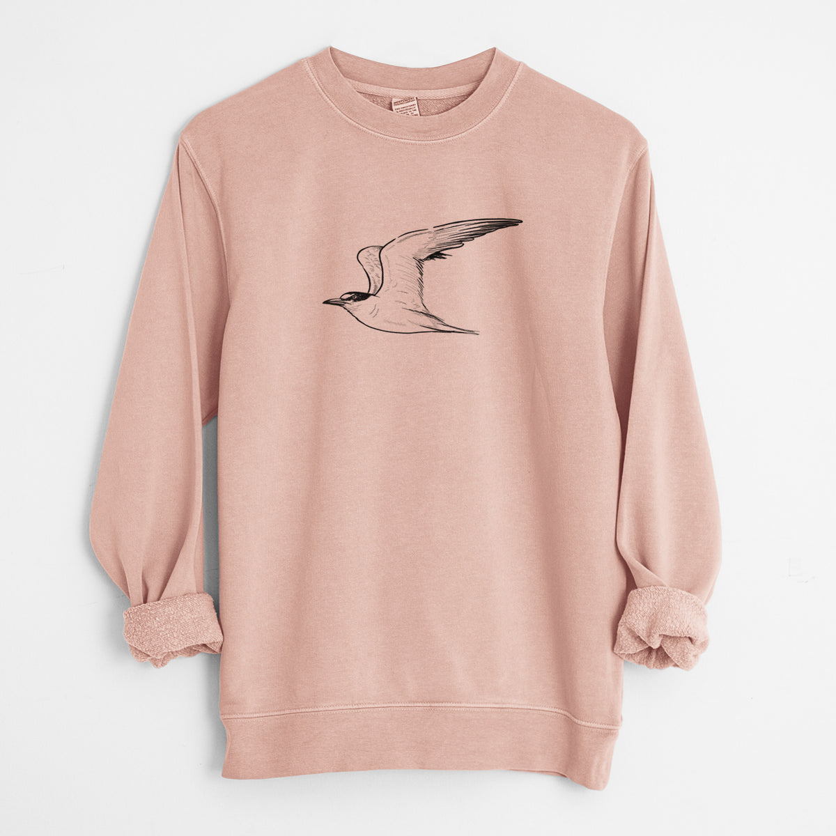 Dusty pink pigment dyed crewneck sweatshirt laid flat with the sleeves rolled, printed with a black ink illustration of a California least tern in flight.