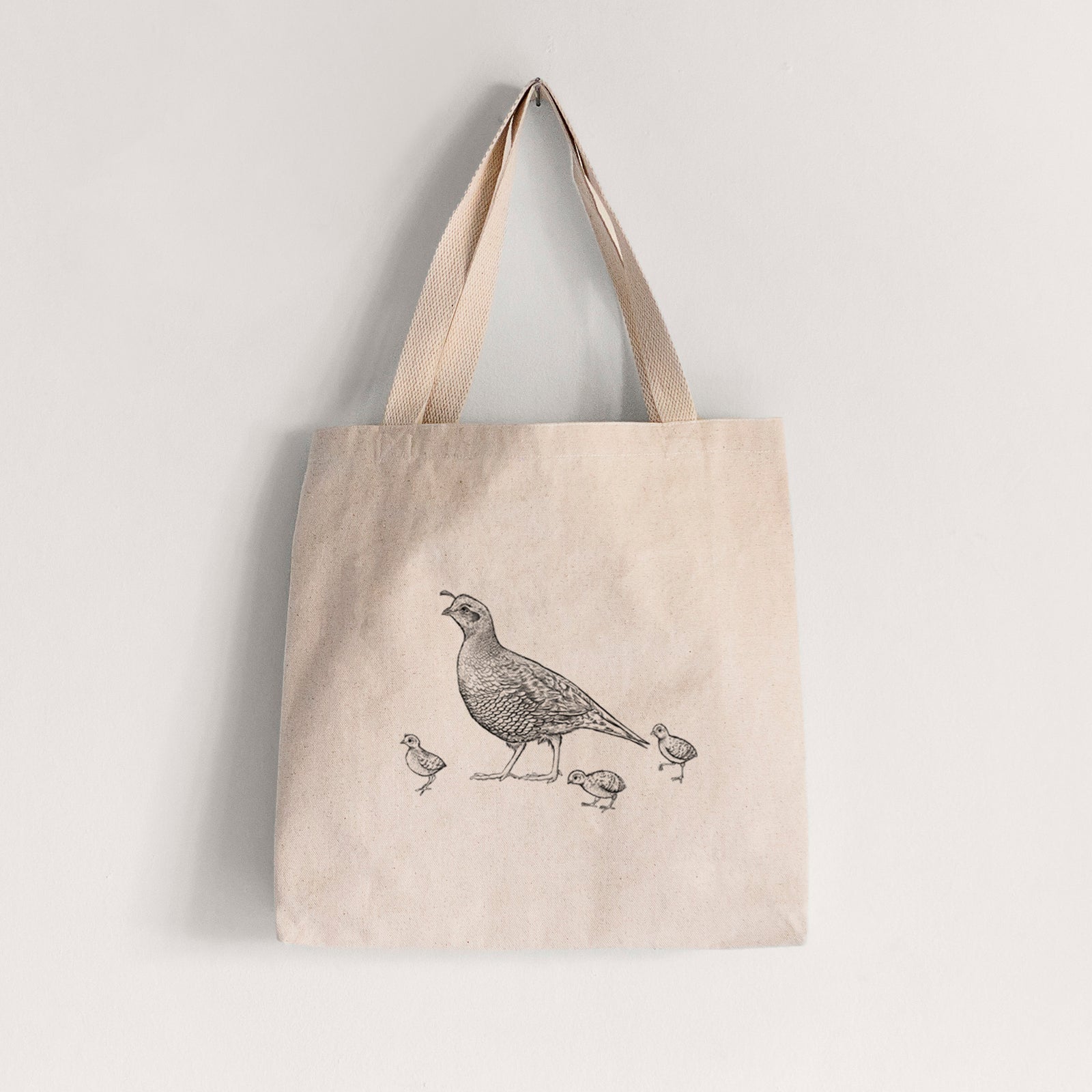 Natural canvas tote bag printed with a black ink illustration of a California quail with its chicks.
