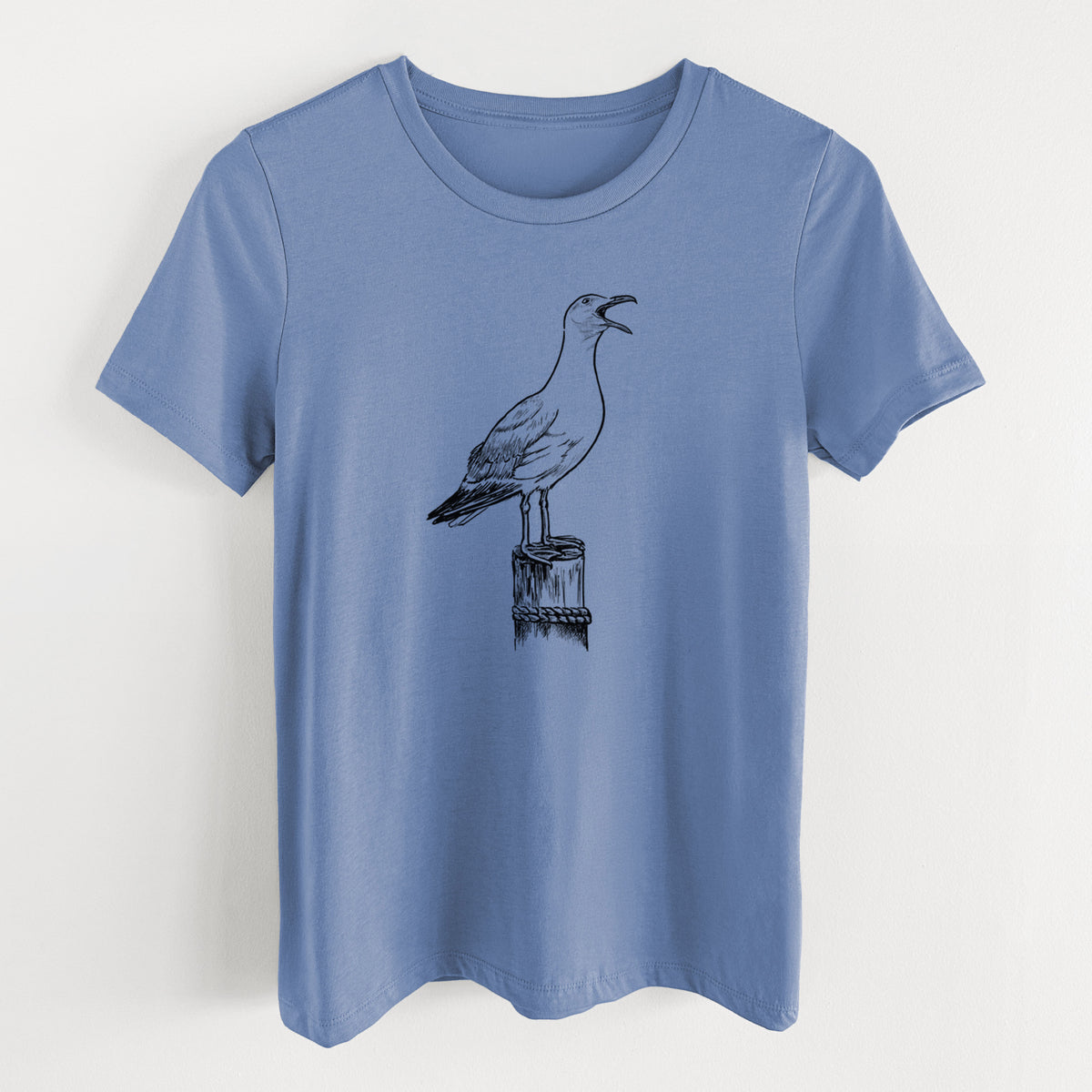 Blue bell women's relaxed fit cotton t-shirt laid flat, printed with a black ink illustration of a California gull calling from a wooden post.