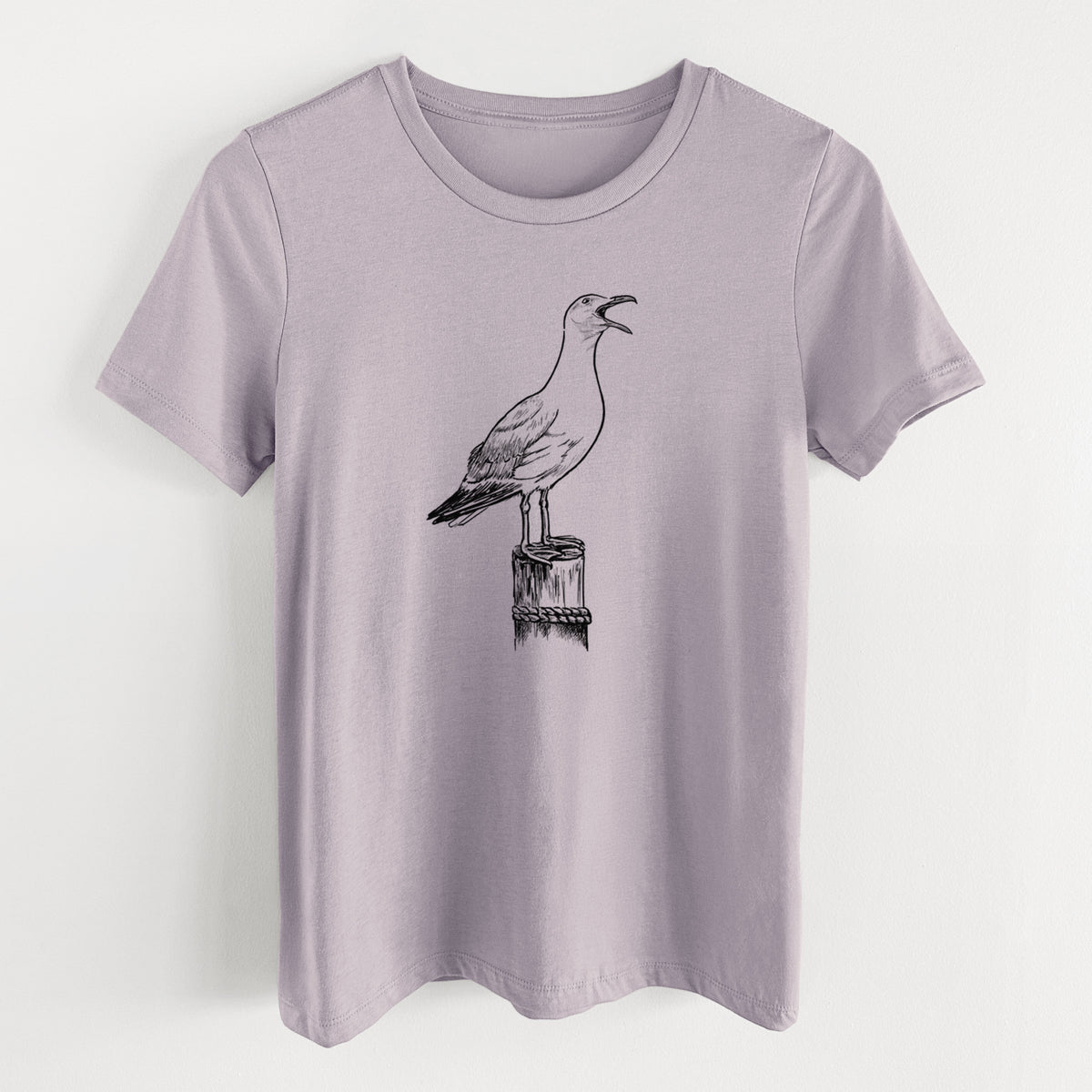 Light violet women's relaxed fit cotton t-shirt laid flat, printed with a black ink illustration of a California gull calling from a wooden post.