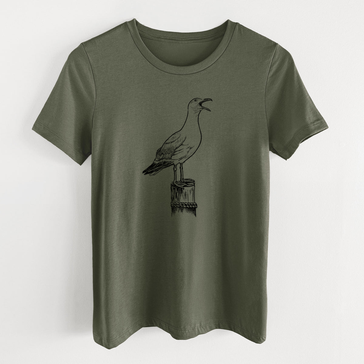 Military green women's relaxed fit cotton t-shirt laid flat, printed with a black ink illustration of a California gull calling from a wooden post.