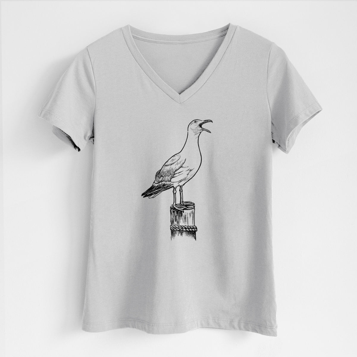 Lunar grey women's relaxed fit cotton V-neck t-shirt laid flat, printed with a black ink illustration of a California gull calling from a wooden post.